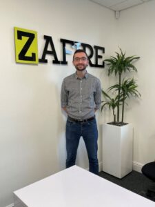 A photograph of Chris Young, Lead Developer, Zafire Group, at Zafire's global HQ.